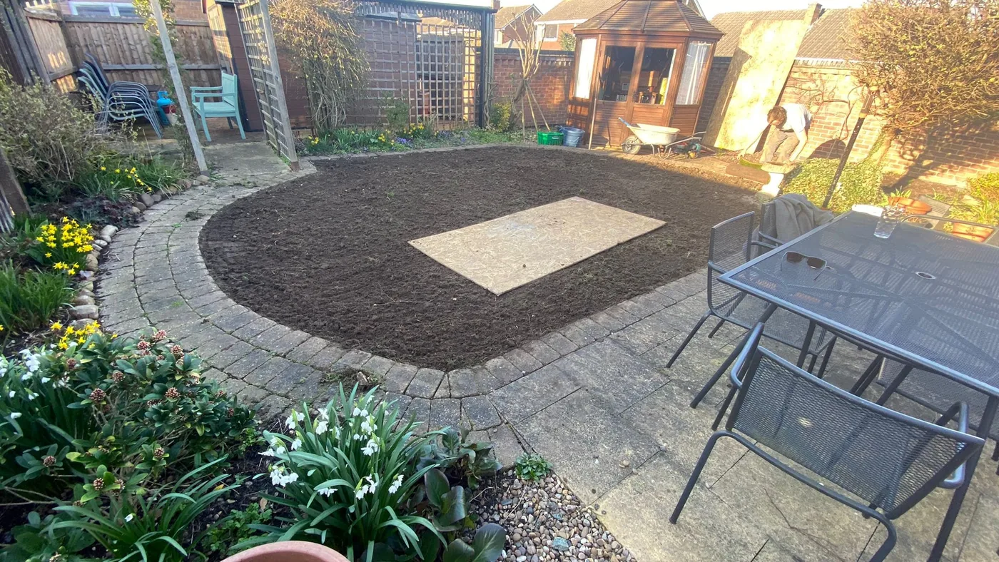Curved patio and landscaped garden seating area